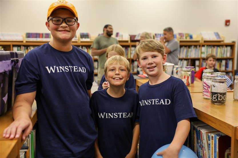 Three boys smile
